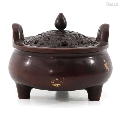 A BRONZE TRIPOD CENSER