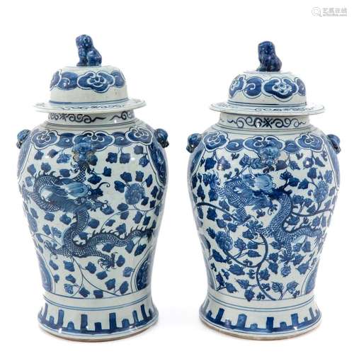 A PAIR OF BLUE AND WHITE JARS WITH COVERS