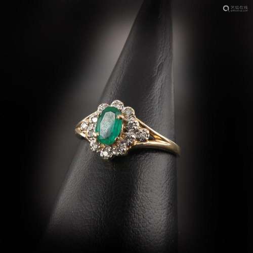 A Ladies 14KG Diamond and Emerald Ring
