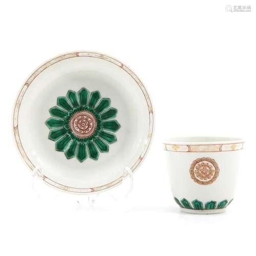 A POLYCHROME DECOR CUP AND SAUCER