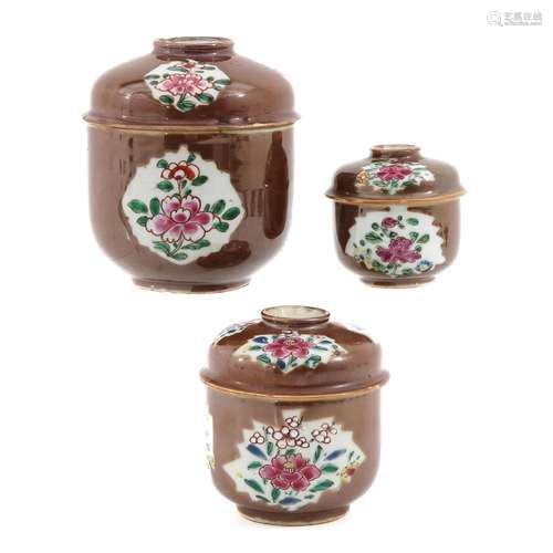 A SET OF 3 JARS WITH COVERS