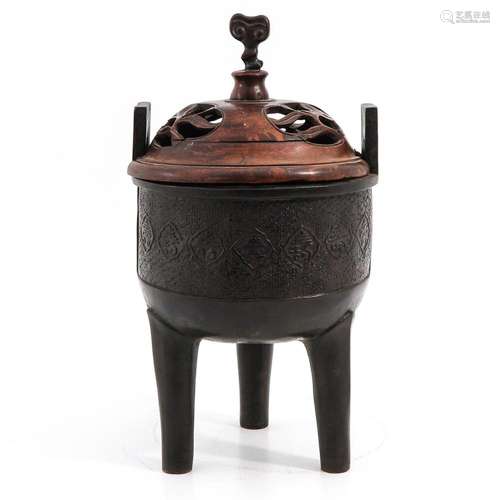 A BRONZE TRIPOD CENSER