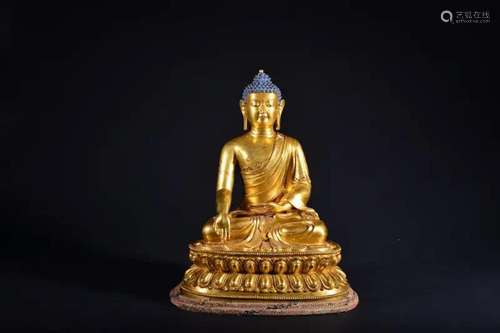 A GILT-BRONZE FIGURE OF SAKYAMUNI.MING PERIOD