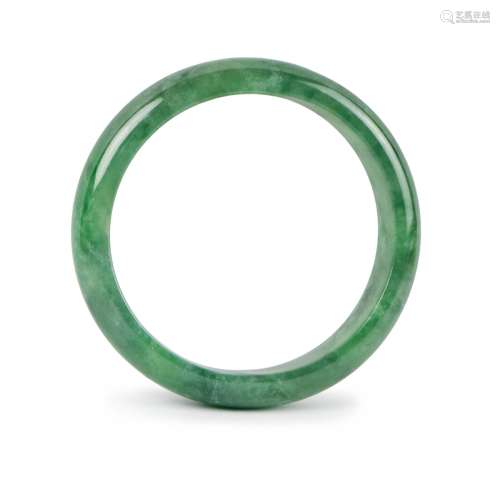 A GREEN JADE CARVED BANGLE