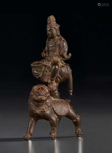 A BRONZE FIGURE OF WENSHU SEATED ON A LION