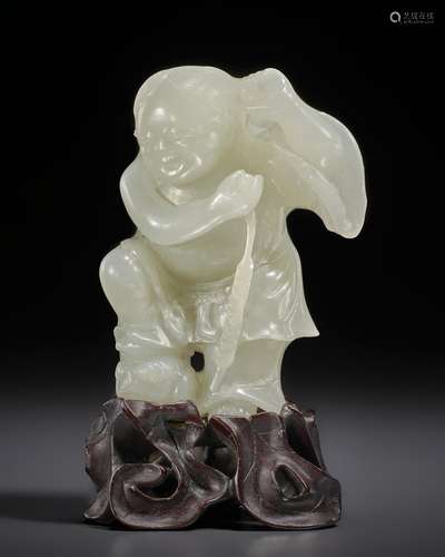 A SMALL GREENISH-WHITE JADE FIGURE OF LIU HAI