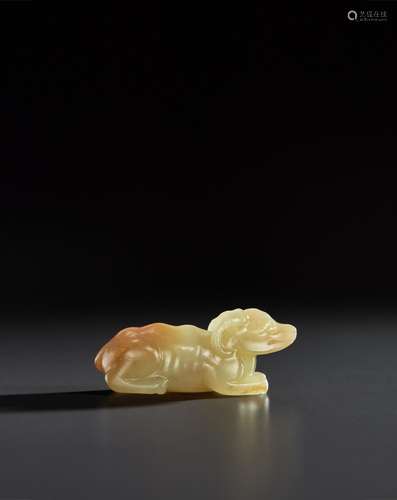 A SMALL YELLOW JADE FIGURE OF A HORNED BEAST