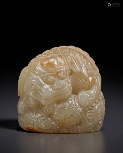 A SMALL GREYISH-BEIGE JADE CARVING OF A BUDDHIST LION