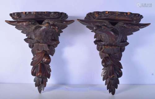 A pair of carved Black forest wooden sconces in the form of ...