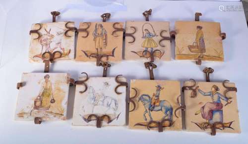 A set of eight wrought iron mounted continental tiles . 20 x...
