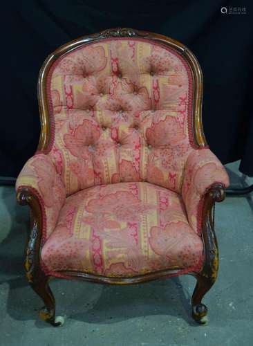 A Victorian carved walnut framed armchair, floral decorated ...