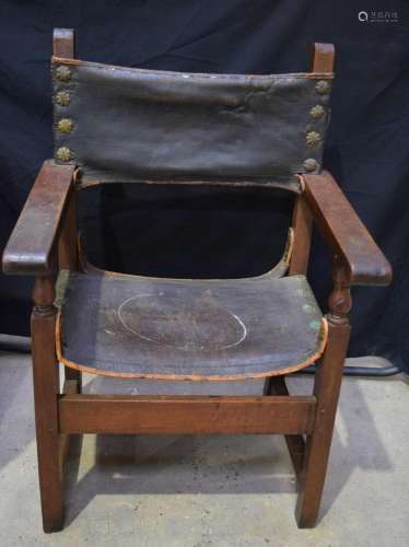 An antique continental Wood and leather chair .107 x 64 x 52...