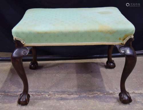 An antique upholstered with claw feet 47 x 67 x 51 cm.