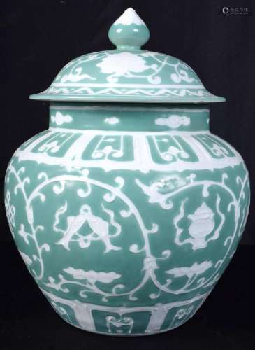 A Chinese porcelain green ground jar and cover decorated wit...