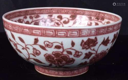 A Chinese porcelain red under glazed bowl decorated with fol...