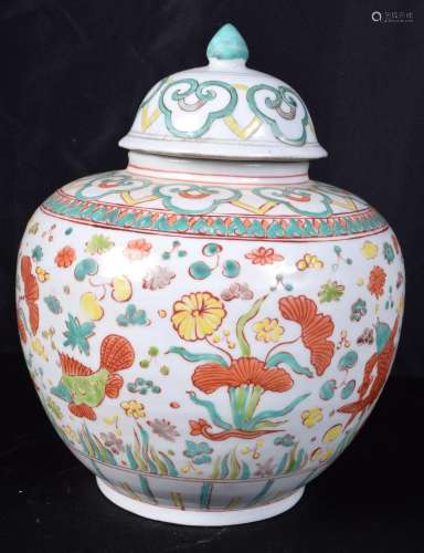 A Chinese porcelain Wucai jar and cover decorated with fish ...