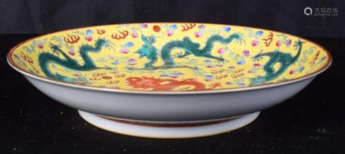 A Chinese porcelain yellow ground dish decorated with dragon...