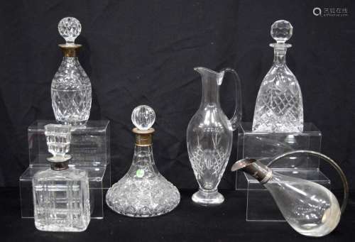 A collection of lead crystal cut glass decanters two with si...