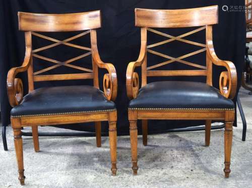 A pair of Italian wooden reception chairs with leather uphol...