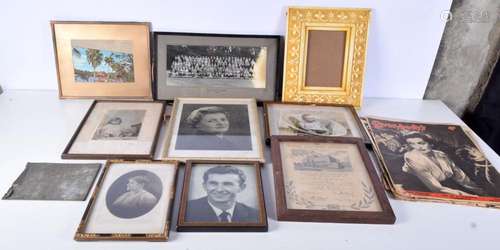 A collection of framed photographs and 1950's magazines