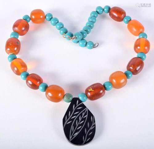 A Turquoise and Amber stone necklace 59 cm.