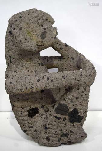 A large South American volcanic stone figure of a seated mal...