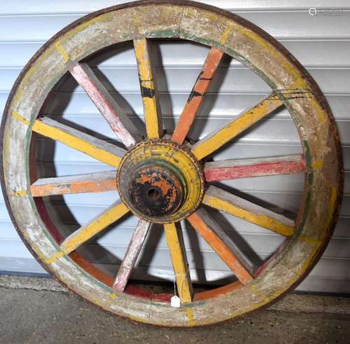 A large antique agricultural cart wheel with Iron rim band 1...