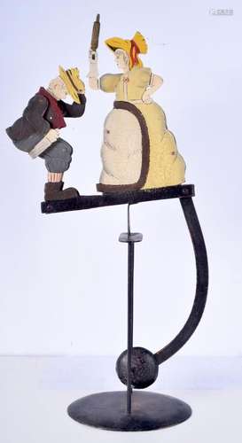 An unusual folk art automaton of a male and female modelled ...