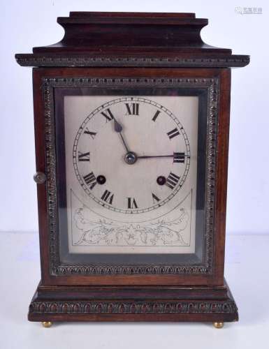 A wooden mantel clock with a silvered dial. 34cm high