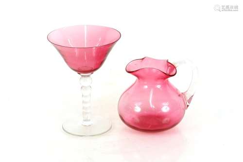 A Victorian cranberry glass jug,with folded neck and clear g...