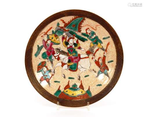 A Chinese crackle glazed shallow dish,decorated warriors in ...