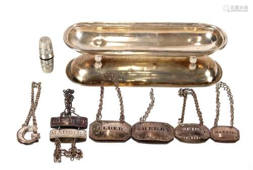 A white metal pen tray,raised on fluted ball feet, 19cm long...