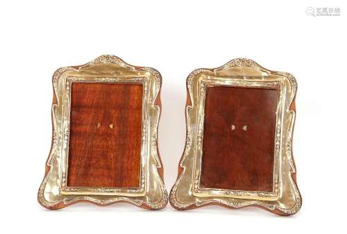 A pair of silver mounted easel photograph frames,with raised...