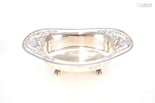 A continentaloval white metal bread basket,with foliate embo...