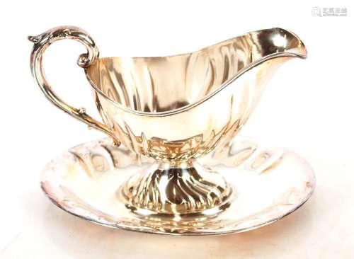 A continental white metal gravy boat,on integral stand stamp...