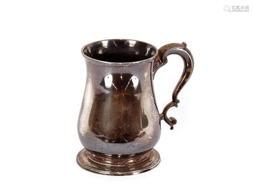 A George II silver baluster tankard,having scroll handle rai...