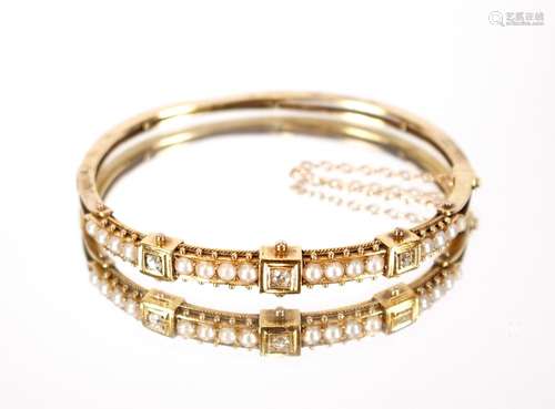 A yellow metal diamond and seed pearl set bangle