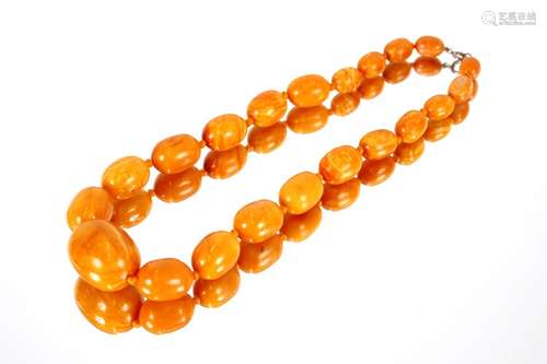 A butterscotch amber coloured graduatednecklace; a Lola Rose...