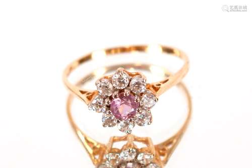 A gold white stone and mauve set cluster ring