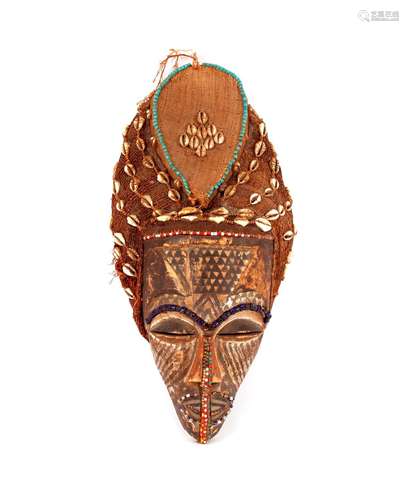 An African carved wooden face mask,with bead and sack decora...