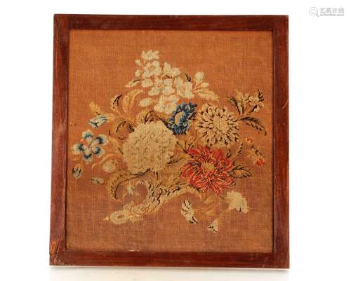 An early 19th Century embroidery of flowers,in mahogany fram...