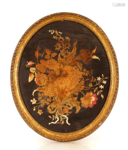 An antique oval needlework study,of flowers dated 1779, 57cm...