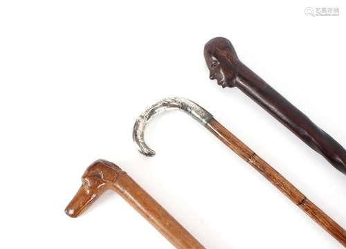 Three walking sticks,including a dogs head example; another ...