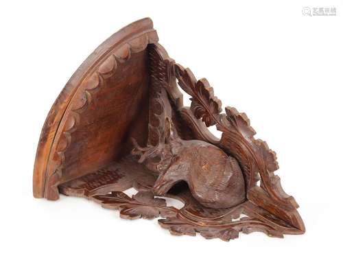 A Black Forest style carved wooden corner shelf,with stag de...