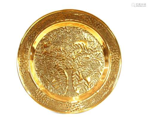 A large circular brass tray,with foliate decoration, 90cm di...