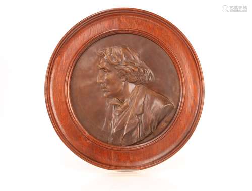 A bronze circular plaque,of Sir Henry Irving contained in an...