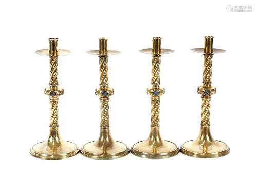 A set of four 19th Century brass ecclesiasticalcandlesticks,...