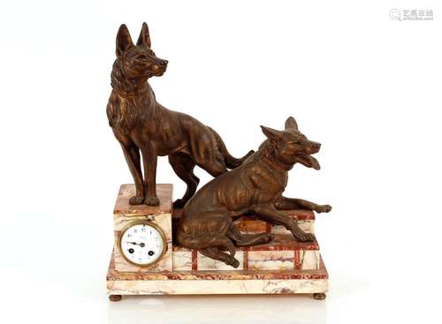 A French marble and bronze clock,surmounted by dogs on a ste...