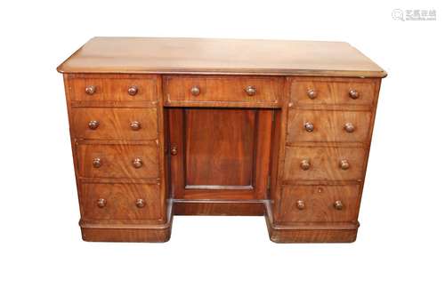 A Victorian mahogany kneehole writing desk,fitted with a cen...