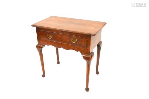 A George III oak low boy,the overhanging top above a single ...